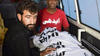 Abdul Majeed sits beside Shafqat's body in an ambulance