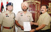 Commisioner of police Arpit Shukla honouring assistant sub-inspector Mohan Singh in Jalandhar