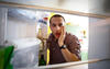 Man looking in refrigerator
