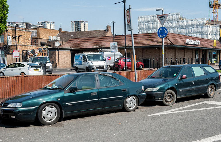 Eastern European migrants sleep in 10 cars